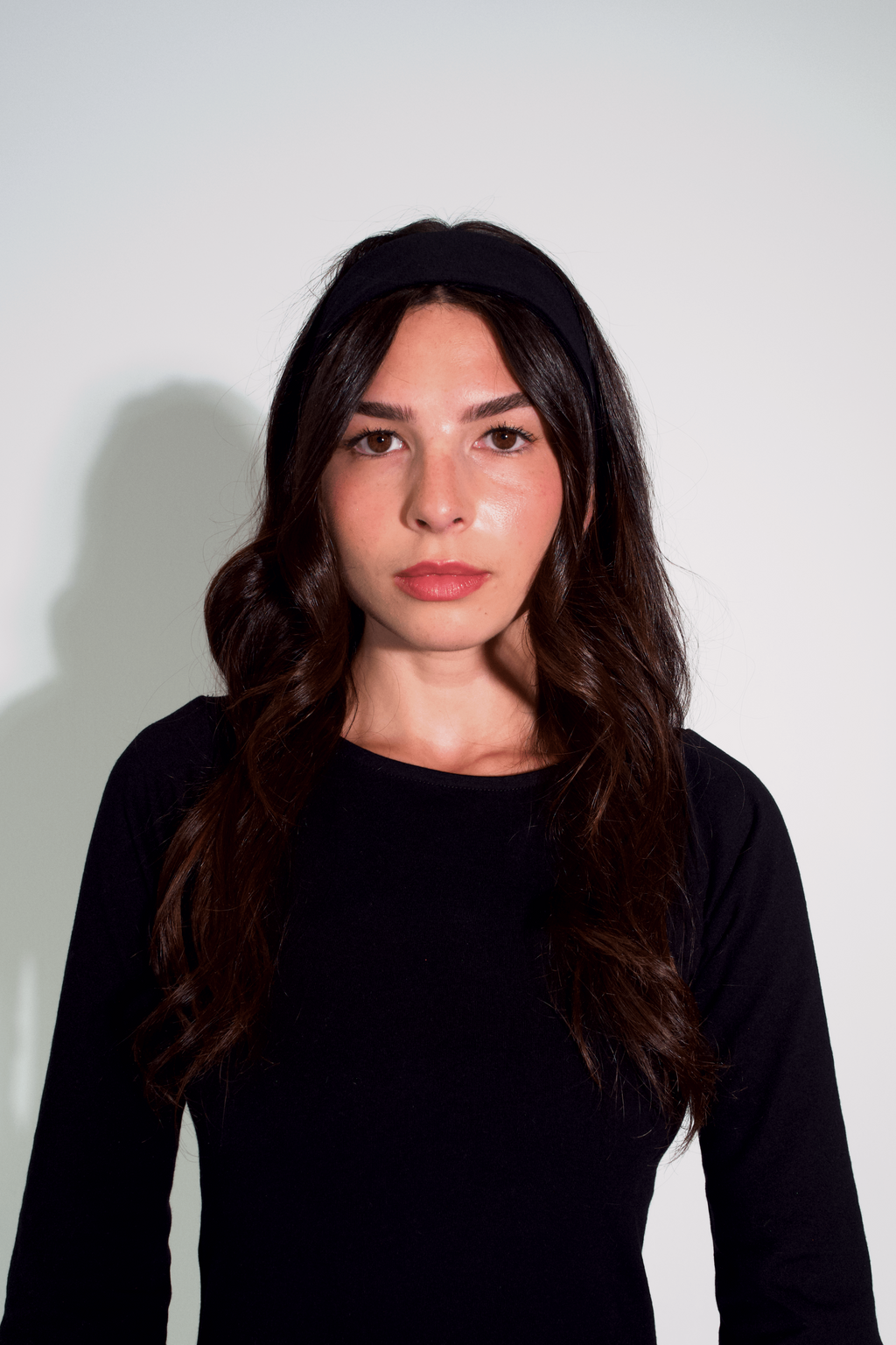 Woman wearing a black top against a white background