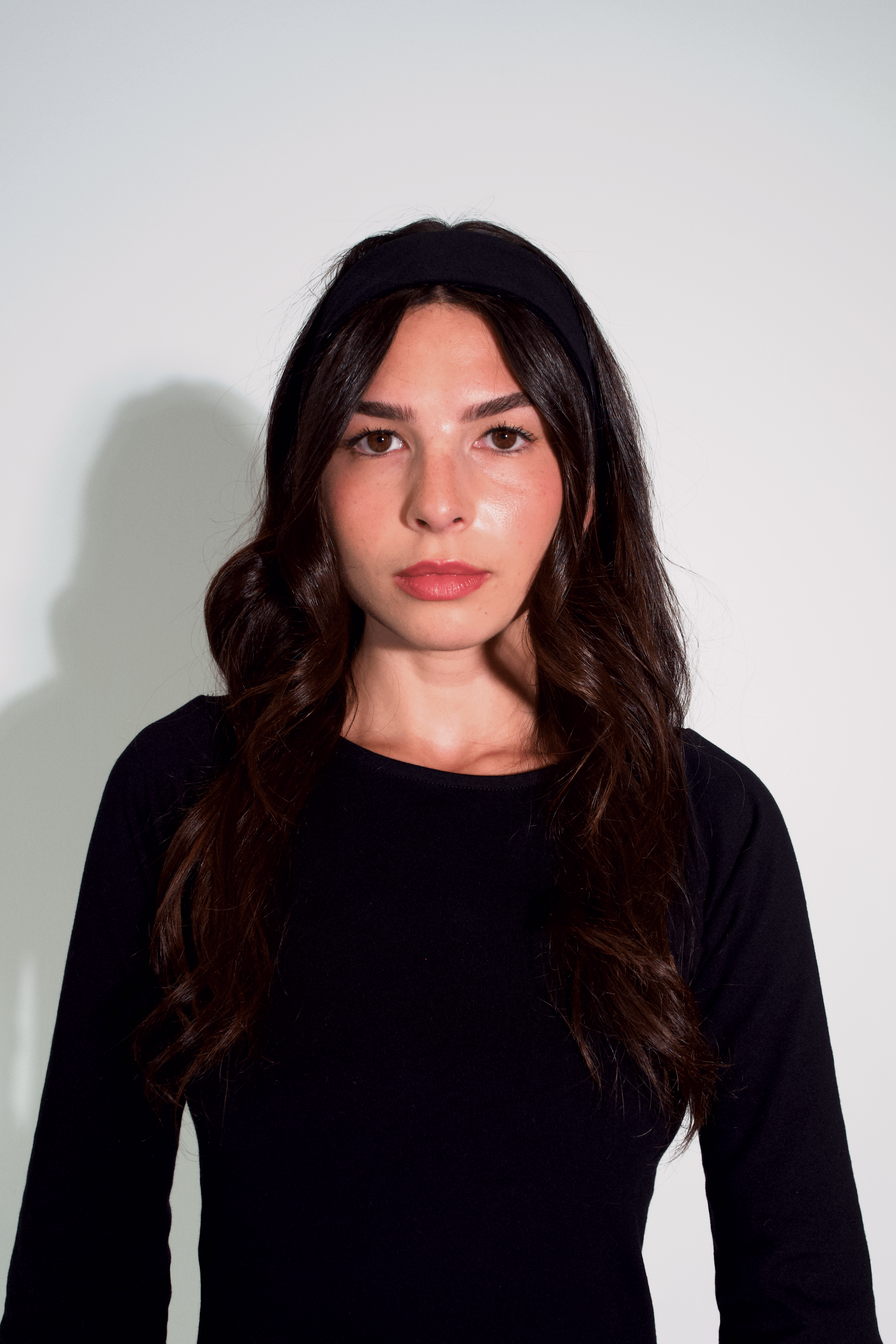 Woman wearing a black top against a white background