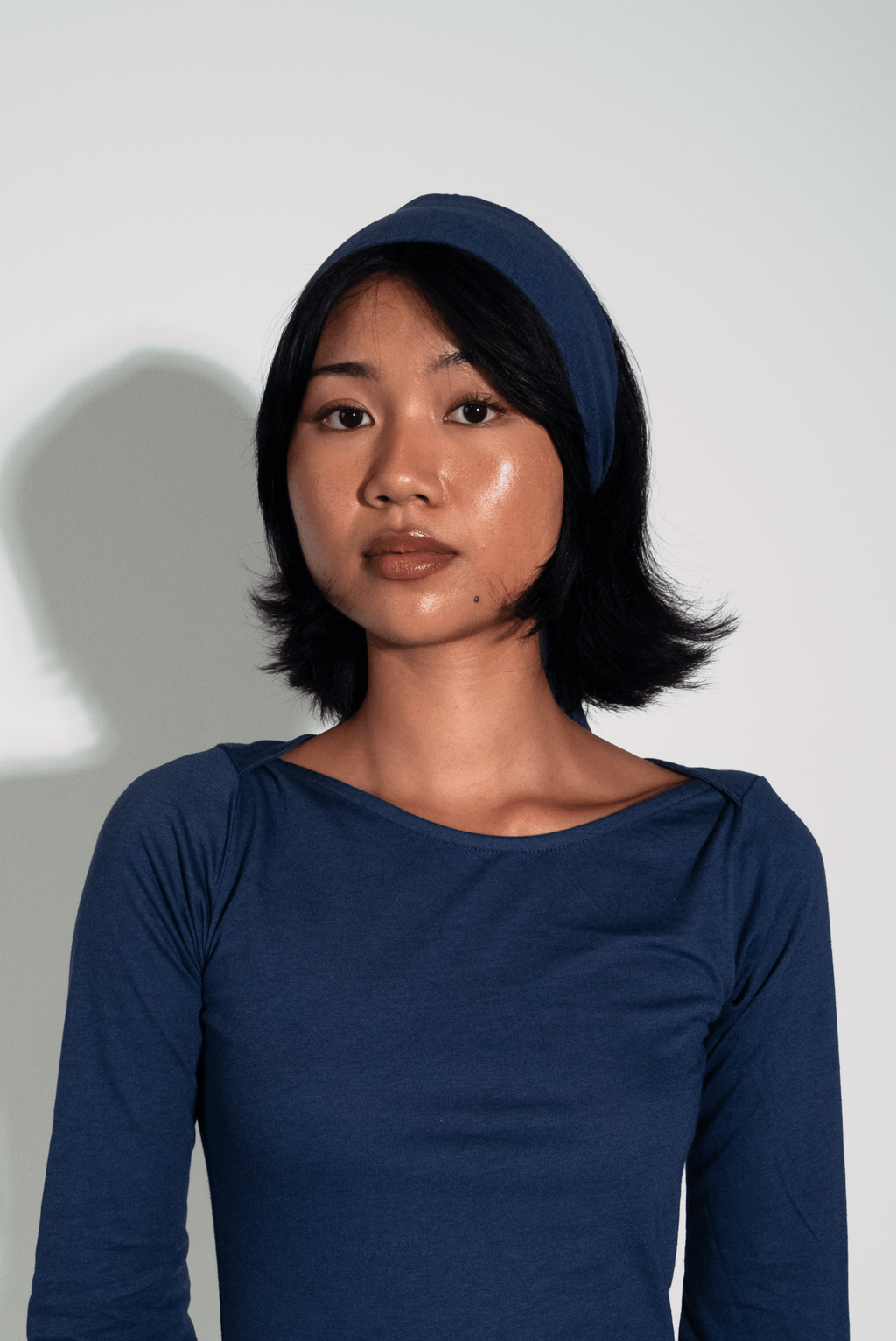 Woman wearing a blue dress against a white background