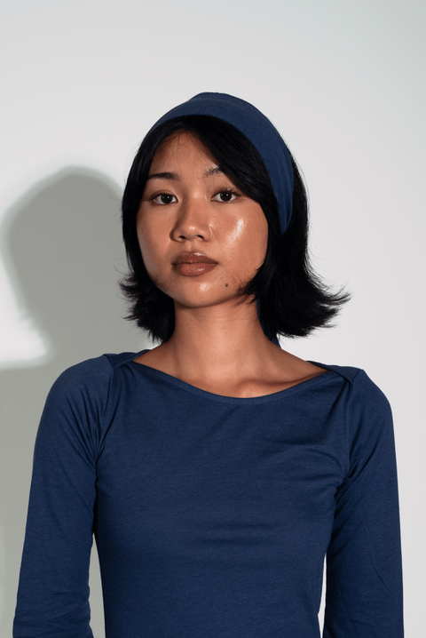 Woman wearing a blue dress against a white background