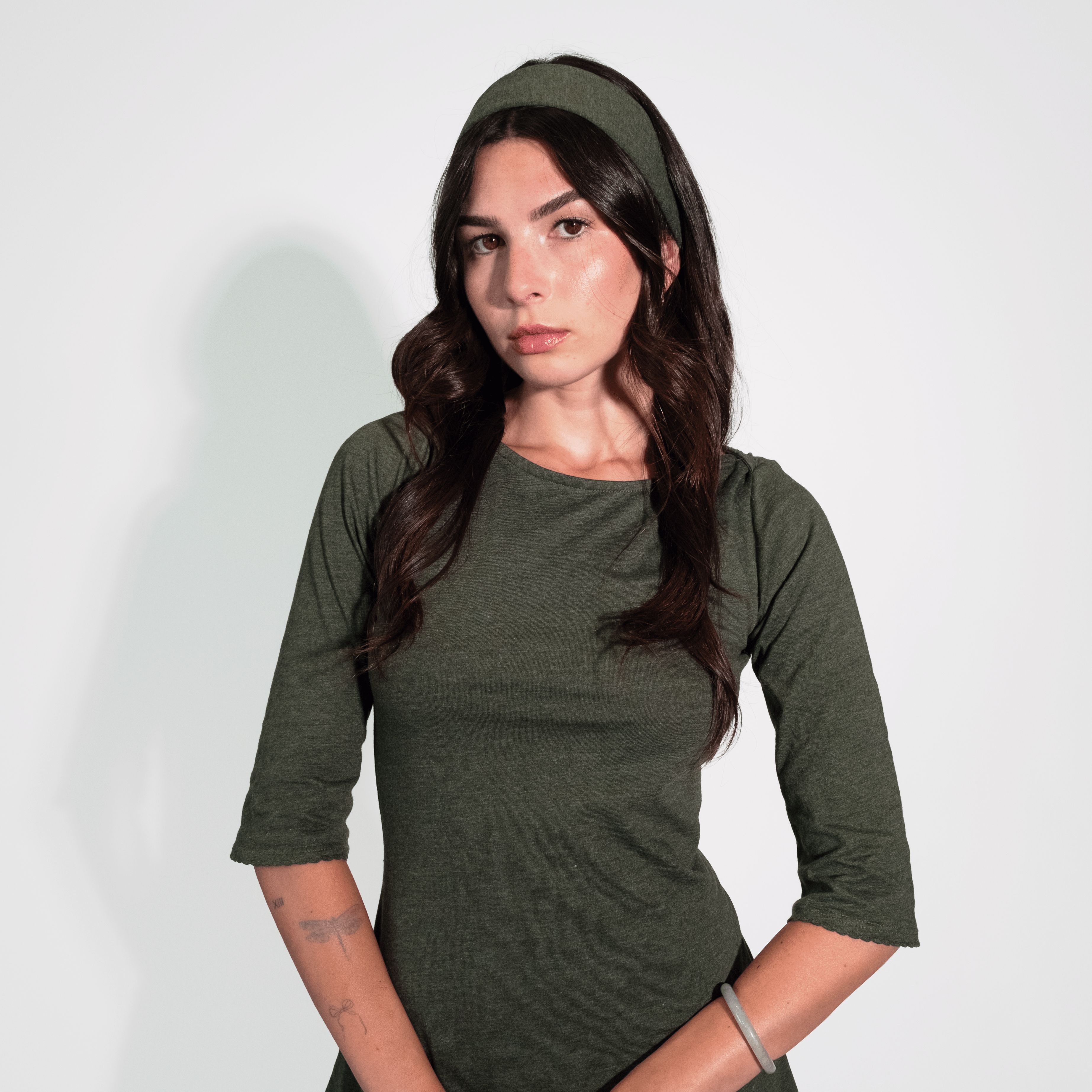 Woman wearing a green dress against a white background