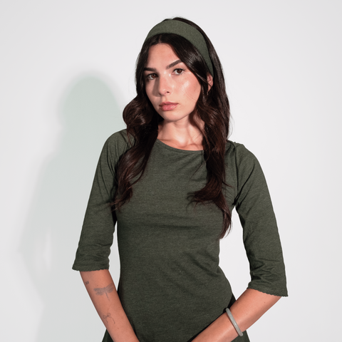 Woman wearing a green dress against a white background